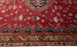 Corner detail of 2000s Shiraz rug showing border pattern and Wool pile
