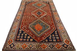 Surface texture of 2000s Shiraz rug with natural Wool and intricate pattern