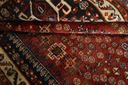Corner detail of 2000s Shiraz rug showing border pattern and Wool pile