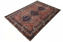 Corner detail of 2000s Shiraz rug showing border pattern and Wool pile