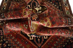 Corner detail of 2000s Shiraz rug showing border pattern and Wool pile