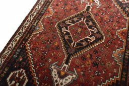Backside of handmade 2000s Shiraz rug showing knot structure and weave density