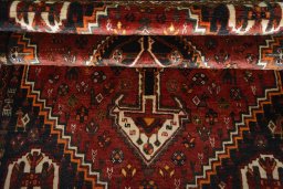 Full view of 2000s Shiraz rug from Iran / Persia, 171 × 121 cm in Red tones