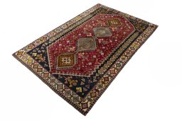 Corner detail of 2000s Shiraz rug showing border pattern and Wool pile