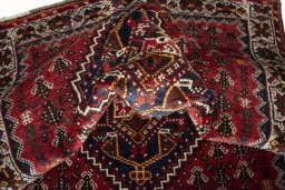 Corner detail of 2000s Shiraz rug showing border pattern and Wool pile