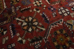 Backside of handmade 2000s Shiraz rug showing knot structure and weave density