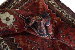 Corner detail of 2000s Shiraz rug showing border pattern and Wool pile