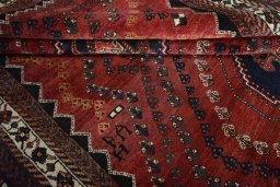 Full view of 2000s Shiraz rug from Iran / Persia, 304 × 212 cm in Red tones