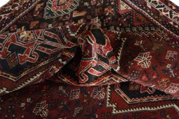 Corner detail of 2000s Shiraz rug showing border pattern and Wool pile