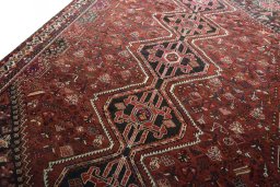 Backside of handmade 2000s Shiraz rug showing knot structure and weave density