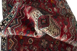 Corner detail of 2000s Shiraz rug showing border pattern and Wool pile