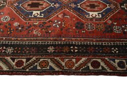 Corner detail of 2000s Shiraz rug showing border pattern and Wool pile