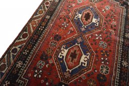 Backside of handmade 2000s Shiraz rug showing knot structure and weave density