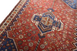 Backside of handmade 2000s Shiraz rug showing knot structure and weave density