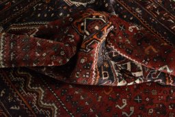 Surface texture of 2000s Shiraz rug with natural Wool and intricate pattern