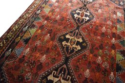 Backside of handmade 2000s Shiraz rug showing knot structure and weave density