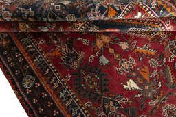 Corner detail of 2000s Shiraz rug showing border pattern and Wool pile
