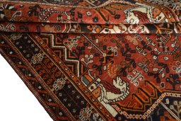 Corner detail of 2000s Shiraz rug showing border pattern and Wool pile