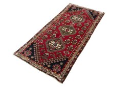 Corner detail of 2000s Shiraz rug showing border pattern and Wool pile