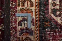 Backside of handmade 2000s Shiraz rug showing knot structure and weave density