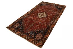 Corner detail of 2000s Shiraz rug showing border pattern and Wool pile