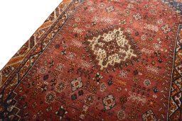 Backside of handmade 2000s Shiraz rug showing knot structure and weave density