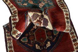 Corner detail of 2000s Shiraz rug showing border pattern and Wool pile