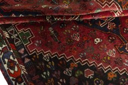 Full view of 1970s Shiraz rug from Iran / Persia, 256 × 172 cm in Red tones