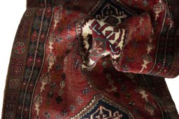 Corner detail of 2000s Shiraz rug showing border pattern and Wool pile
