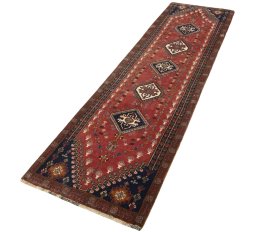 Corner detail of 2000s Shiraz rug showing border pattern and Wool pile