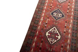 Backside of handmade 2000s Shiraz rug showing knot structure and weave density