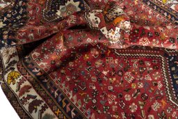 Corner detail of 2000s Shiraz rug showing border pattern and Wool pile