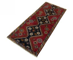 Corner detail of 2000s Shiraz rug showing border pattern and Wool pile