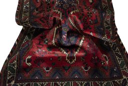 Corner detail of 2000s Shiraz rug showing border pattern and Wool pile