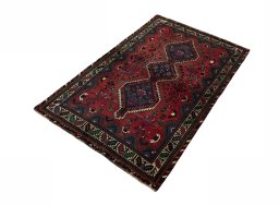 Corner detail of 2000s Shiraz rug showing border pattern and Wool pile