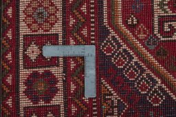 Backside of handmade 2000s Shiraz rug showing knot structure and weave density