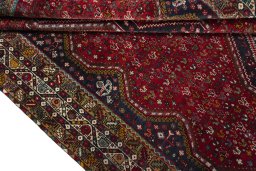 Corner detail of 2000s Shiraz rug showing border pattern and Wool pile