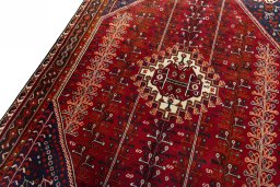 Backside of handmade 2000s Shiraz rug showing knot structure and weave density