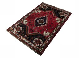 Corner detail of 2000s Shiraz rug showing border pattern and Wool pile