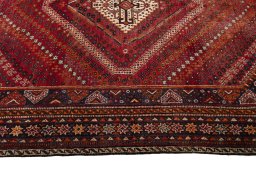 Corner detail of 2000s Shiraz rug showing border pattern and Wool pile