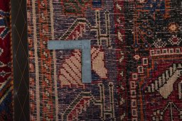 Backside of handmade 2000s Shiraz rug showing knot structure and weave density