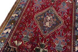 Backside of handmade 2000s Shiraz rug showing knot structure and weave density