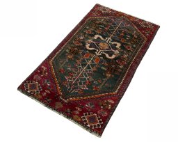 Corner detail of 2000s Shiraz rug showing border pattern and Wool pile