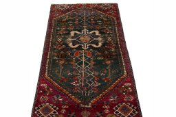 Surface texture of 2000s Shiraz rug with natural Wool and intricate pattern