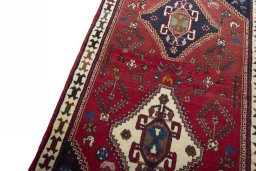Backside of handmade 2000s Shiraz rug showing knot structure and weave density
