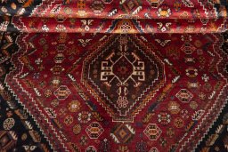 Corner detail of 2000s Shiraz rug showing border pattern and Wool pile