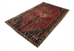 Corner detail of 2000s Shiraz rug showing border pattern and Wool pile