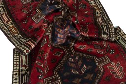 Corner detail of 2000s Shiraz rug showing border pattern and Wool pile