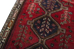 Backside of handmade 2000s Shiraz rug showing knot structure and weave density