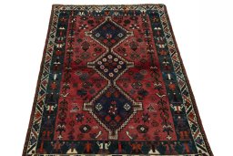 Surface texture of 2000s Shiraz rug with natural Wool and intricate pattern